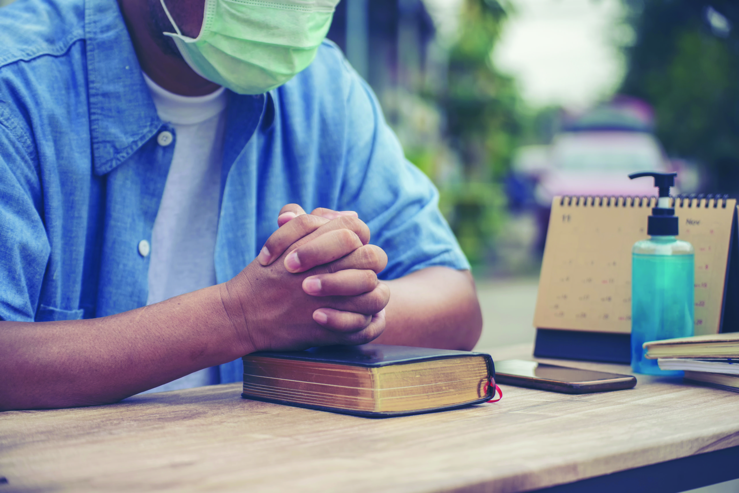 Prayer and bible concept. Asian senior man wear medical mask pra