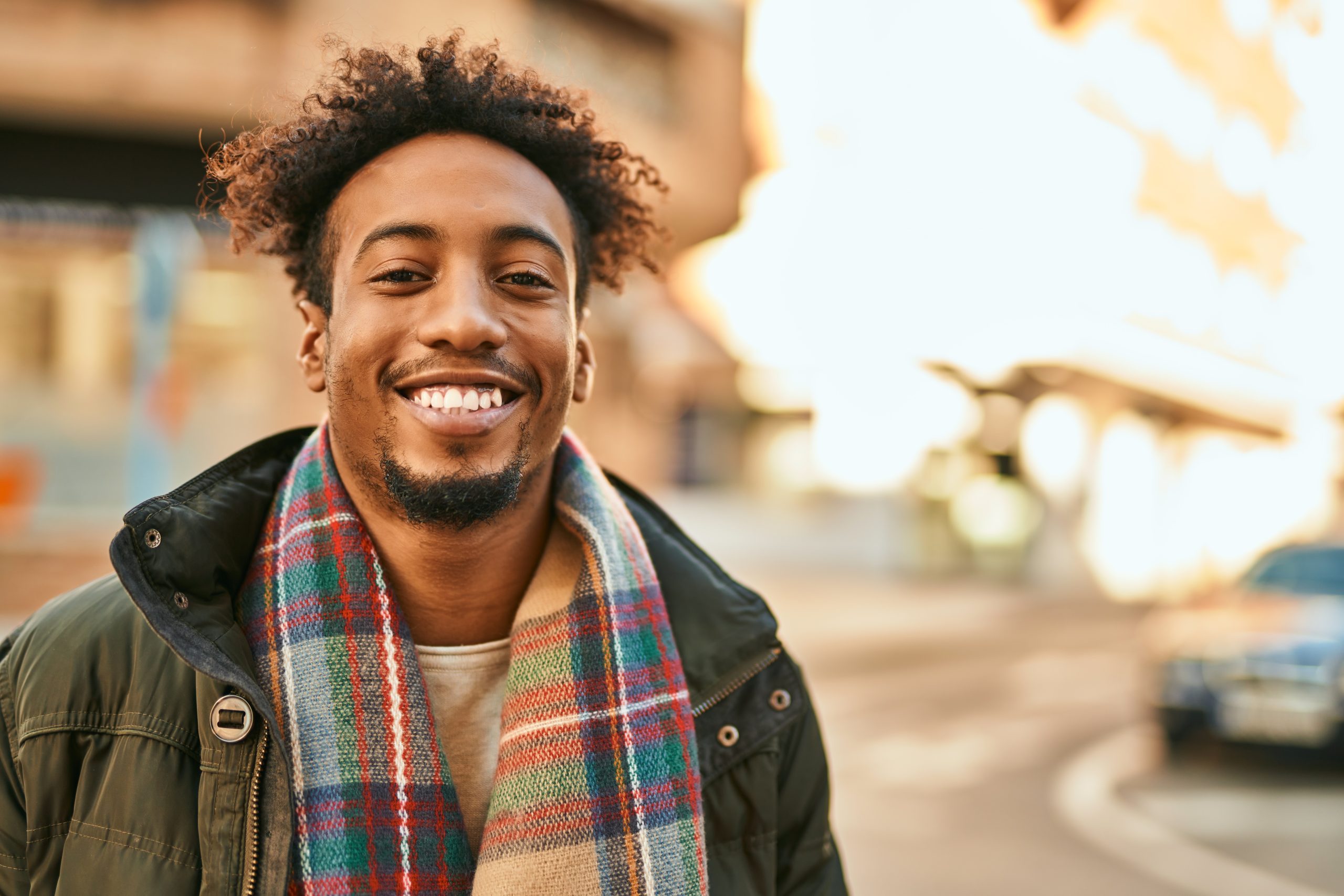 Young african american man smiling happy standing at the city